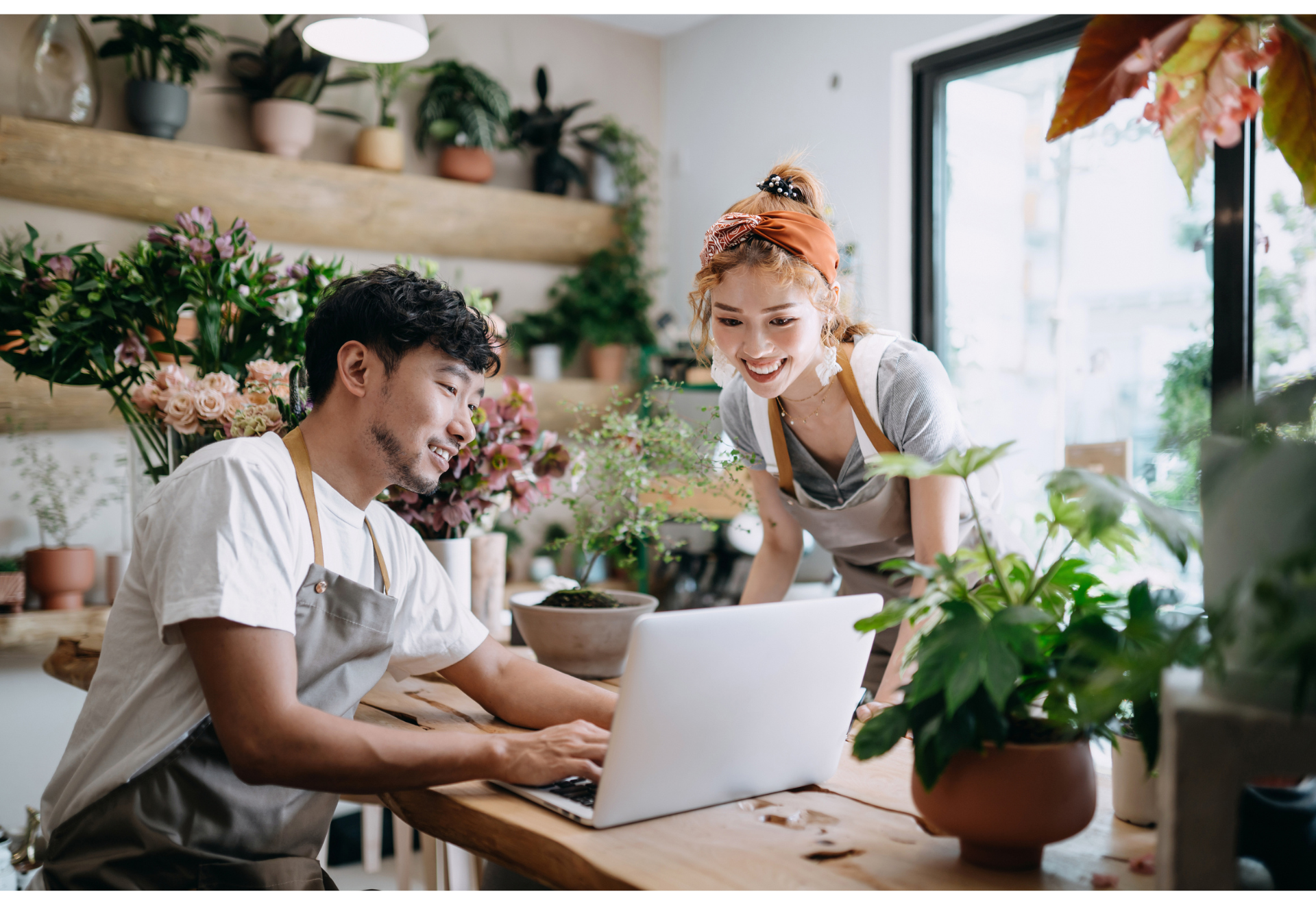 two small business owners looking at laptop